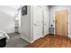Condo entryway with hardwood floors next to a carpeted bedroom entrance at 2958 Syracuse St # 214, Denver, CO 80238