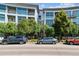 Modern condo building with covered entry, large windows and mature trees at 2958 Syracuse St # 214, Denver, CO 80238