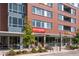 A daytime exterior view of the modern community with storefronts, restaurants and inviting streetscape at 2958 Syracuse St # 214, Denver, CO 80238