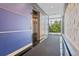 Hallway featuring an elevator, carpet runner, and large window providing natural light at 2958 Syracuse St # 214, Denver, CO 80238