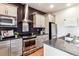 Modern kitchen with stainless steel appliances, granite countertops, and stylish gray cabinets at 2958 Syracuse St # 214, Denver, CO 80238