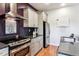 Close-up of the kitchen area with stainless steel appliances, granite countertops, and modern cabinetry at 2958 Syracuse St # 214, Denver, CO 80238