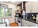 A view of the kitchen featuring stainless appliances and granite countertops at 2958 Syracuse St # 214, Denver, CO 80238