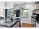 Modern kitchen with granite countertops, stainless steel appliances, and a large window with a green view at 2958 Syracuse St # 214, Denver, CO 80238