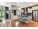 Open kitchen layout with stainless steel appliances and an island with bar stools at 2958 Syracuse St # 214, Denver, CO 80238