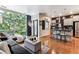 Open-concept living and kitchen area with hardwood floors and natural light at 2958 Syracuse St # 214, Denver, CO 80238