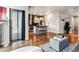 Spacious living room with hardwood floors and a view of the modern kitchen at 2958 Syracuse St # 214, Denver, CO 80238