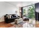 Cozy living room featuring comfortable seating, a large window with natural light, and hardwood floors at 2958 Syracuse St # 214, Denver, CO 80238