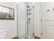 Tiled shower with glass door and door in bathroom at 2958 Syracuse St # 214, Denver, CO 80238