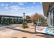 A daytime street view with restaurants and shops featuring sidewalk seating and a well-maintained streetscape at 2958 Syracuse St # 214, Denver, CO 80238