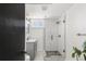 Modern basement bathroom with a glass shower and gray vanity at 1765 S Irving St, Denver, CO 80219