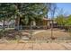 Charming ivy-covered bungalow home with a fenced yard and mature trees at 2000 S Columbine St, Denver, CO 80210