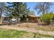 Charming bungalow with established yard, large trees, and front fence at 2000 S Columbine St, Denver, CO 80210