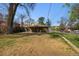 Large grassy backyard with mature trees and a patio area at 2000 S Columbine St, Denver, CO 80210