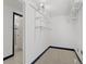 Walk-in closet with custom shelving, carpet floor and an ensuite bathroom with frameless shower door at 4842 Steele St, Denver, CO 80216