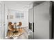 Dining area with modern table and chairs, stainless steel refrigerator, and natural light at 4842 Steele St, Denver, CO 80216