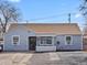 A quaint one-story home featuring a fresh exterior, tidy yard and paved driveway at 4842 Steele St, Denver, CO 80216