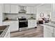 Well-appointed kitchen with modern appliances and adjacent open-concept living space at 4842 Steele St, Denver, CO 80216