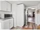 View of kitchen and entrance featuring microwave on the counter and fridge at 4842 Steele St, Denver, CO 80216