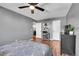 Bedroom featuring wood floors, ceiling fan, and a TV at 7973 Chase Cir # 56, Arvada, CO 80003