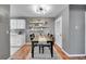 Dining area with table, chairs, decor shelves, and laminate flooring with gray paint at 7973 Chase Cir # 56, Arvada, CO 80003