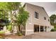 Exterior view of a multi-level home with a two car garage and mature trees in a neighborhood at 7973 Chase Cir # 56, Arvada, CO 80003