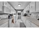 Bright kitchen featuring white appliances, ample cabinet space, and a window for natural light at 7973 Chase Cir # 56, Arvada, CO 80003