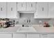 The kitchen features white cabinets and appliances, with ample counter space for meal preparation at 7973 Chase Cir # 56, Arvada, CO 80003