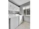 Bright laundry room with washer, dryer, overhead cabinets, and window at 7973 Chase Cir # 56, Arvada, CO 80003