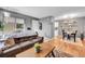 Cozy living room featuring a brown sofa, hardwood floors, and stylish decor at 7973 Chase Cir # 56, Arvada, CO 80003