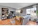Comfortable living room with natural light, laminate floors, gray walls, and cozy furnishings at 7973 Chase Cir # 56, Arvada, CO 80003