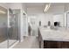 Main bathroom with walk-in shower and double vanity at 12289 Coral Burst Ln, Parker, CO 80134