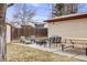 Backyard oasis offering a cozy fire pit area, modern patio furniture, and a picnic table for outdoor enjoyment at 1308 W 102Nd Ave, Northglenn, CO 80260