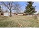 Expansive backyard with a well-maintained lawn, mature trees, and a storage shed for outdoor enjoyment at 1308 W 102Nd Ave, Northglenn, CO 80260