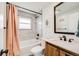 Updated bathroom features a shower-tub combination with white subway tile and a modern vanity with wood cabinets at 1308 W 102Nd Ave, Northglenn, CO 80260