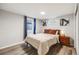 Comfortable bedroom features hardwood floors, neutral walls, and a large window letting in plenty of natural light at 1308 W 102Nd Ave, Northglenn, CO 80260