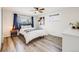 Bright bedroom features hardwood floors, ceiling fan, and a large window letting in plenty of natural light at 1308 W 102Nd Ave, Northglenn, CO 80260