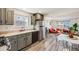 Modern kitchen with stainless steel appliances, gray cabinets, and wood floors at 1308 W 102Nd Ave, Northglenn, CO 80260
