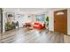 Bright living room featuring wood-look flooring, large windows, and stylish decor at 1308 W 102Nd Ave, Northglenn, CO 80260