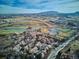 Large aerial view of community near golf course and city at 1060 Cottonwood Cir, Golden, CO 80401