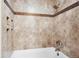 Shower and bathtub with tile surround at 1060 Cottonwood Cir, Golden, CO 80401