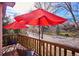 Deck with red umbrellas, chairs, and views of the neighborhood at 1060 Cottonwood Cir, Golden, CO 80401