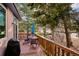 Deck features table, chairs, umbrella, and grill; overlooks a wooded area at 1060 Cottonwood Cir, Golden, CO 80401