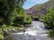 Person surfing on river with Coors Brewery in background at 1060 Cottonwood Cir, Golden, CO 80401