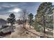 Peaceful backyard view with trees and water at 4266 W Pondview Dr, Littleton, CO 80123