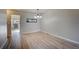 Simple dining area with hardwood floors and a chandelier at 4266 W Pondview Dr, Littleton, CO 80123