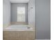 Inviting bathroom with a large soaking tub and tile surround at 9461 Elmhurst Ln # C, Highlands Ranch, CO 80129