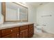 Bathroom featuring a single sink vanity with wooden cabinetry and tiled floors at 9461 Elmhurst Ln # C, Highlands Ranch, CO 80129