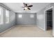 Neutral toned bedroom featuring carpeted flooring, natural light from two windows, and closet at 9461 Elmhurst Ln # C, Highlands Ranch, CO 80129
