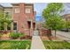 Charming brick exterior with manicured lawn, walkway, and healthy green trees at 9461 Elmhurst Ln # C, Highlands Ranch, CO 80129